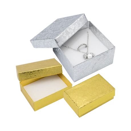 Cajas para joyería de la colección Fiore en acabados dorado y plateado con un elegante diseño floral minimalista.